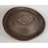 A Tulama People circular rhinoceros hide shield, 19th century, with a raised boss and rim,