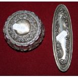 An Edwardian silver and cut glass oval hair tidy, Birmingham 1909 and a similar circular example,