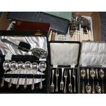 Two cased carving sets, boxed sets of knives, spoons, loose cutlery, cased dessert service