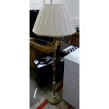 A brass standard lamp with cream frilled shade