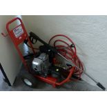 A trolley mounted petrol engined power wash