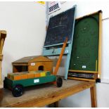 A child's wooden pull-along trolley with bricks, blackboard, Bagatelle game, electronic chess