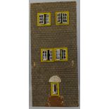 A scratch built wooden dolls house, the simulated brick 3-storey front facade with tin-plate windows