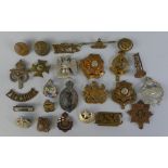 Over twenty military badges, including WW2 tank corps, South Staffordshire regiment, Medical