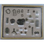 A framed display of metal detector finds, from the Civil War period, including buckles, ammunition