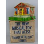 A Mettoy tin-plate "Farmer in the Dell" toy, with hand cranked musical action, 24cm square, boxed