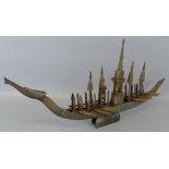 A Malayan carved buffalo horn model of a boat, in the form of a mythological creature with