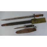 A British pattern 1907 bayonet, with 43cm fullered steel blade, leather covered scabbard and green