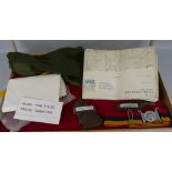 A table top cabinet, containing various military items, including RAMC belt, army olive drab jersey,