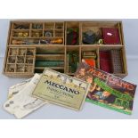 Meccano - a quantity of sections and accessories, in red and green, contained in scratch-built