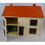 A 1960's wooden doll's house, of double fronted form, with white painted walls and red painted roof,