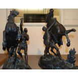 A Victorian pair of spelter rearing Marley horses with attendants, on wooden plinths, 51cm high