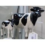 Two Beswick models of a cow and a calf