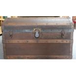 A wooden bound canvas covered cabin trunk