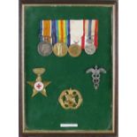 A framed display of WW1 medals and badges awarded to Sister F.I. Cherrill, comprising British War