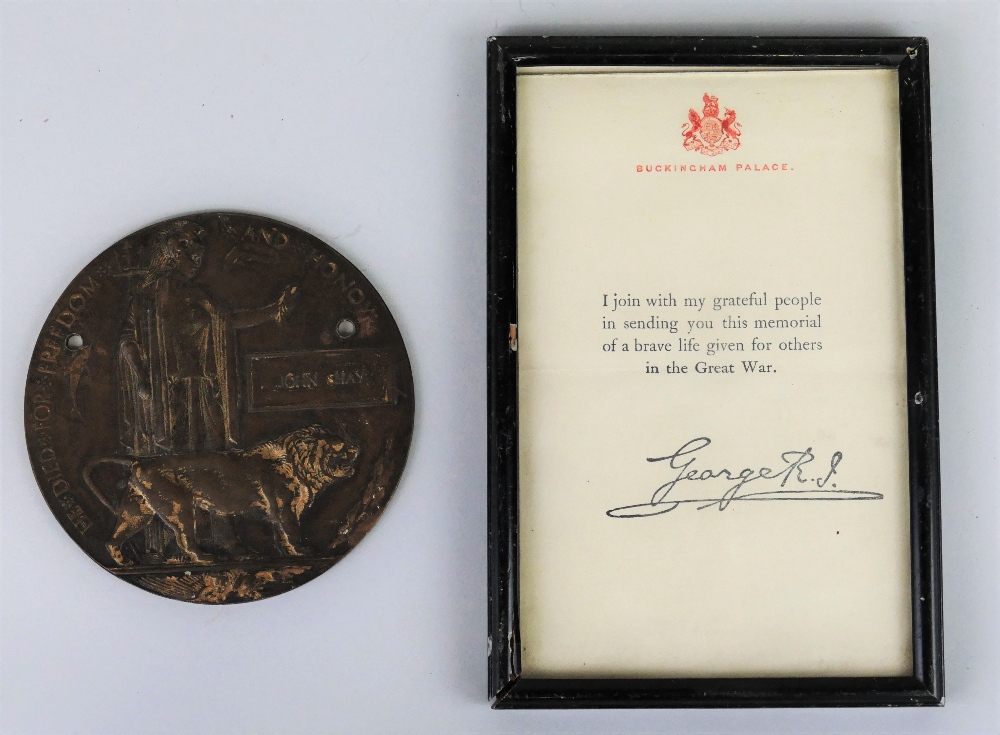 A WW1 bronze memorial plaque, for John Shay, drilled twice for mounting, and a framed printed letter