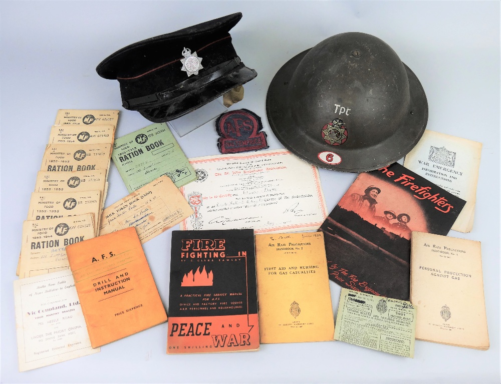 A WWII Auxiliary Fire Service steel helmet, named to Charles Batte No.132980 with cloth badge for