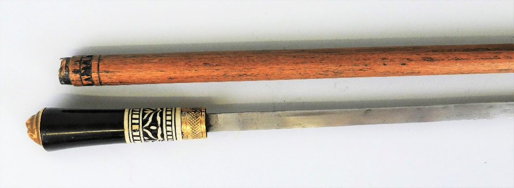 An Indian sword stick, with 61cm steel blade, horn and carved bone handle with brass tigers head