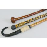 A plaited leather bound cosh, with bulbous end 51cm long, an Indian walking stick, the shaft