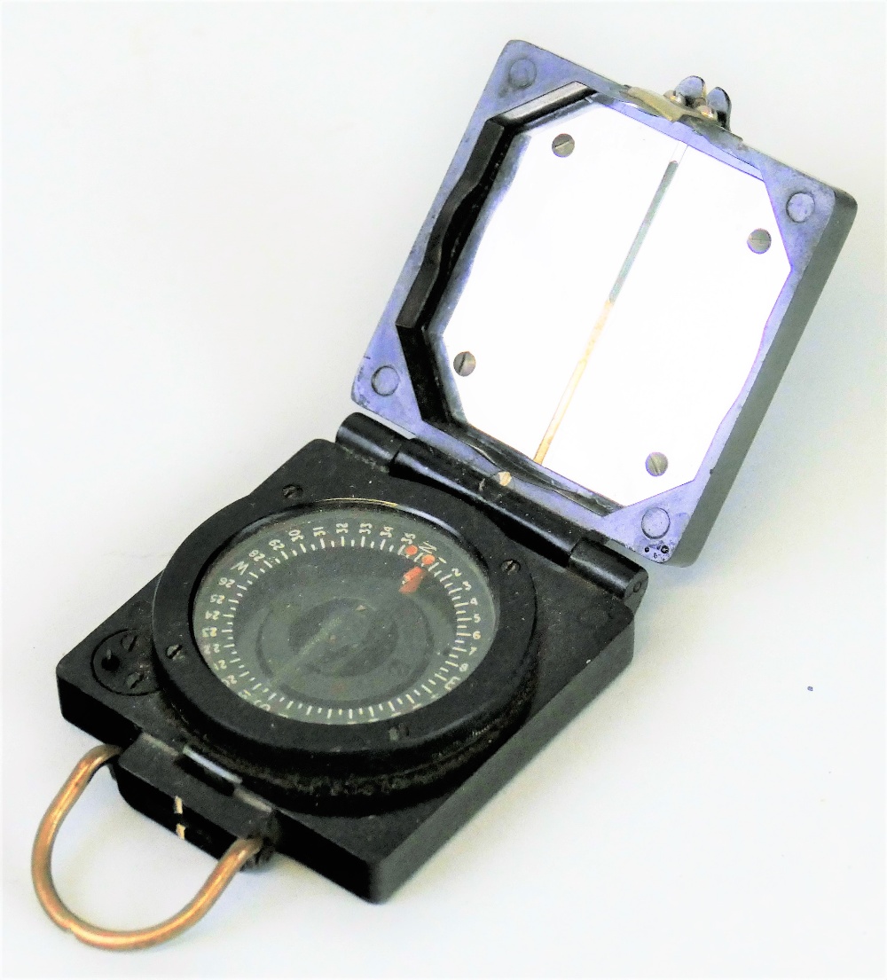 A WWII T.G. Co. Ltd magnetic marching compass, in square bakelite case inscribed with broad arrow