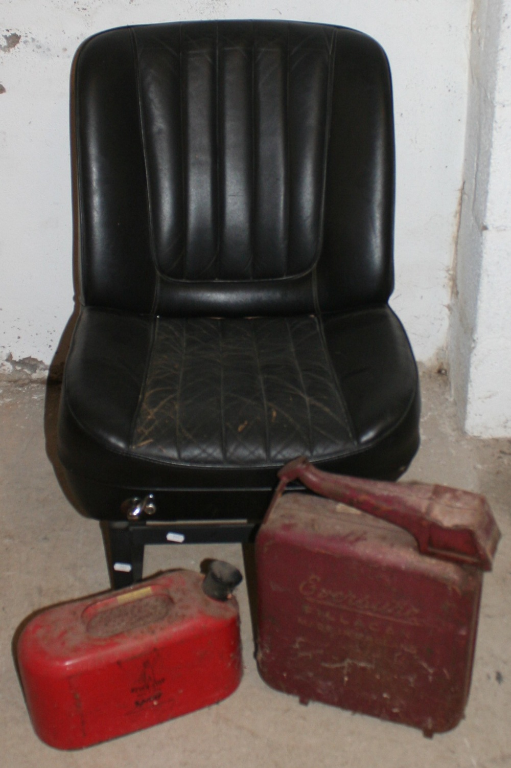 A believed 1970's BMC car seat, converted to a chair together with an Eversure petrol can and a