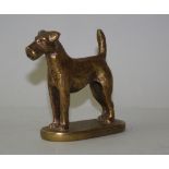 A brass car mascot, signed "Supplied by Wimbledon Car Company", depicting an Airdale dog, 9cm high