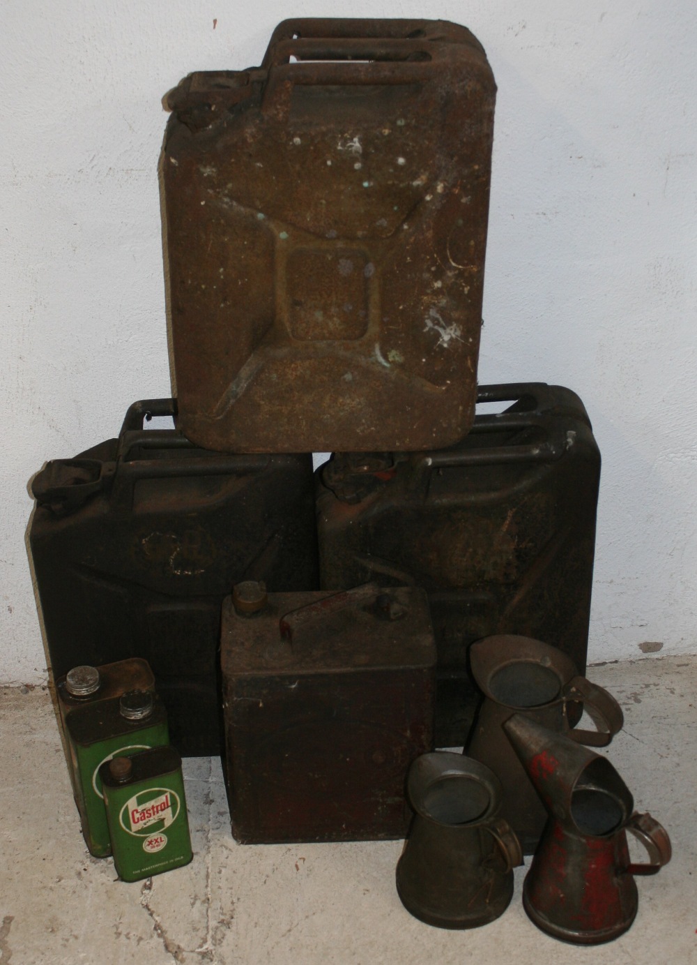 Three War Department Jerry cans, c. 1944/45, an Esso petrol can, three jugs and three Castrol oil