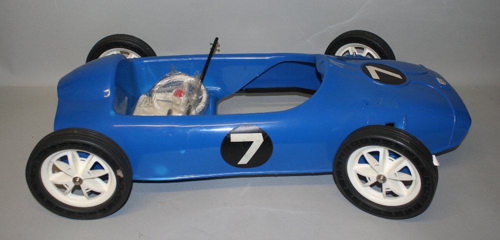 A Triang blue plastic racing peddle car, circa 1960's, not assembled, with box, length 84 cm.
