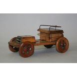 A novelty wood inkwell, in the form of a veteren car with hinged seat revealing the well, length