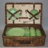 A Coracle picnic basket, the wicker basket containing a pale green service by Stadium for four place