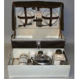 A 1930's Garrison picnic hamper for four place settings, the metal trunk opening to reveal a near