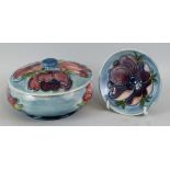 A Moorcroft powder bowl and cover of flattened circular form, tube lined in the Anemone pattern on a