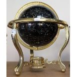 A celestial table globe mounted in a brass frame.