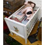 A childs painted cot and five collector's dolls.