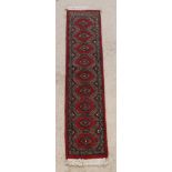 A red and grey ground Uzbek runner with 9 diamonds to the centre 54" x 12"