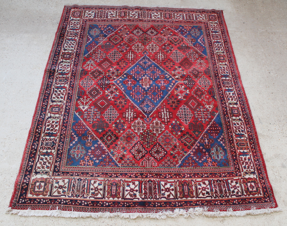 A blue and red ground Persian Joshagan rug with central medallion 118" x 89"There is sign of moth