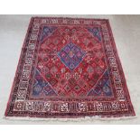 A blue and red ground Persian Joshagan rug with central medallion 118" x 89"There is sign of moth