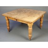 A Victorian light oak rectangular extending dining table, raised on turned supports with 1 extra