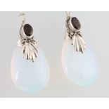 A pair of moon stone style ear drops