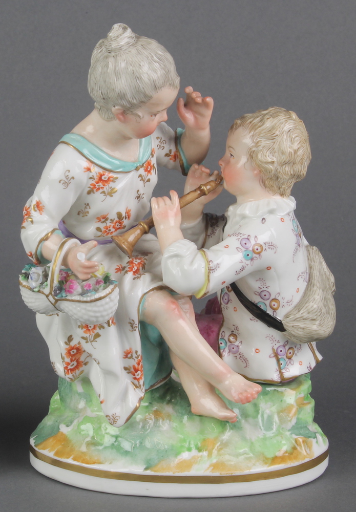 A 19th Century German group of a mother and child on a raised base 7" 1 hand has a broken finger and