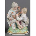 A 19th Century German group of a mother and child on a raised base 7" 1 hand has a broken finger and