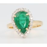 An 18ct white gold pear shaped emerald and diamond ring, the centre stone approx 2.8ct surrounded by