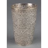 A Persian silver beaker with floral decoration 82 grams 3 1/2 "