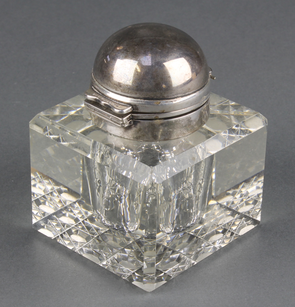 An Edwardian cut glass silver mounted inkwell, London 1903 2 3/4" There are minor chips to the glass