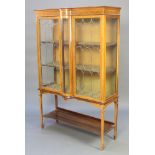 An Edwardian inlaid mahogany display cabinet with shaped cornice enclosed by lead glazed panelled