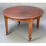 An Edwardian oval inlaid mahogany extending dining table with 2 extra leaves, raised on 4 square