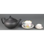 A Wedgwood black basalt teapot of classical form with scroll mop 9", a Dresden cabinet cup and