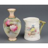 A Royal Worcester baluster vase decorated with roses 3 3/4" and a ditto jug decorated with a blue