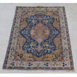 A blue and yellow ground Persian Tabriz rug with central medallion 75" x 54"There are signs of