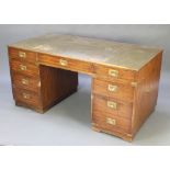 A mahogany military style desk with green leather inset writing surface above 1 long and 8 short